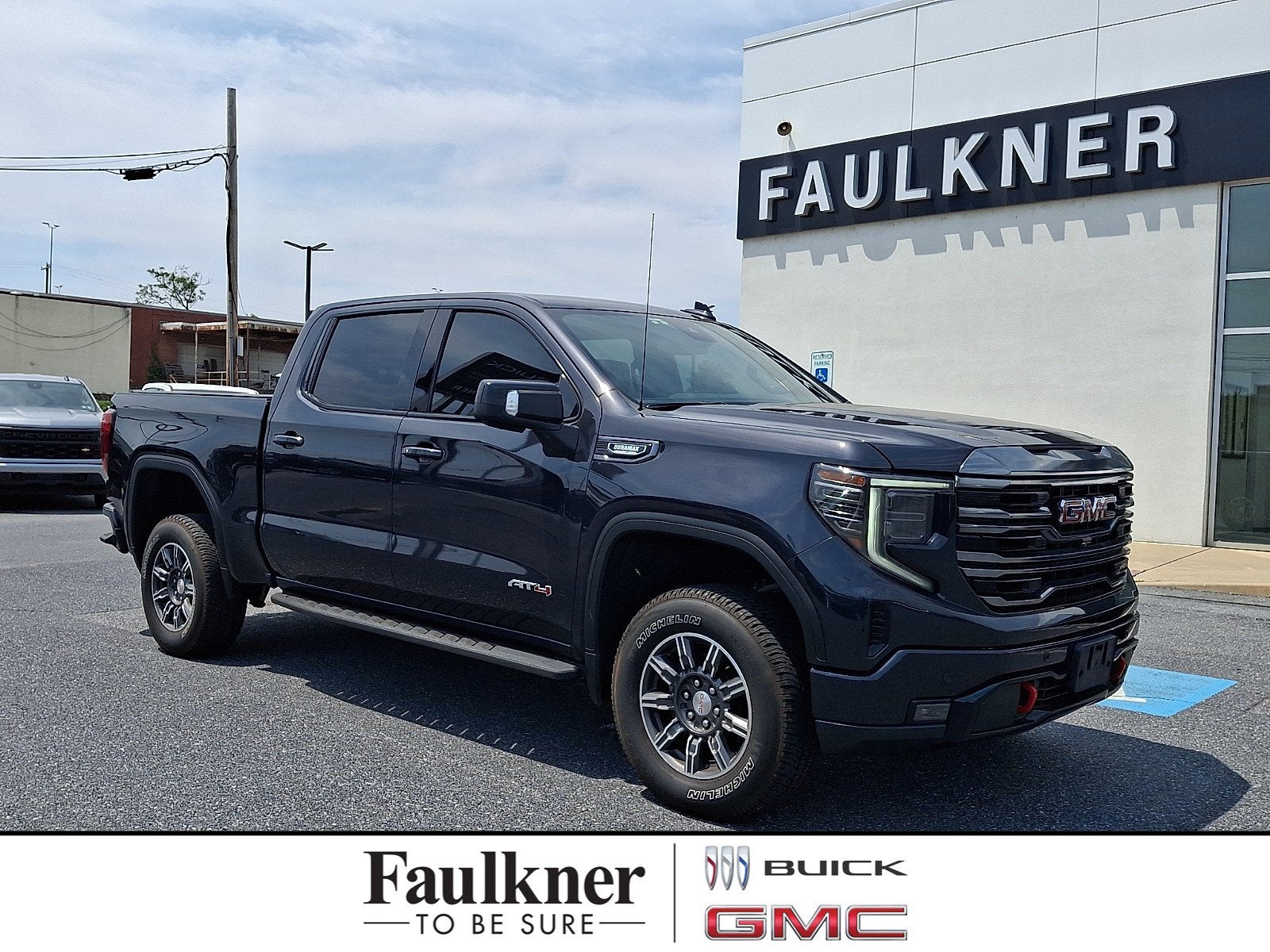 2024 GMC Sierra 1500 AT4 in Titanium Rush Metallic — front three-quarter view