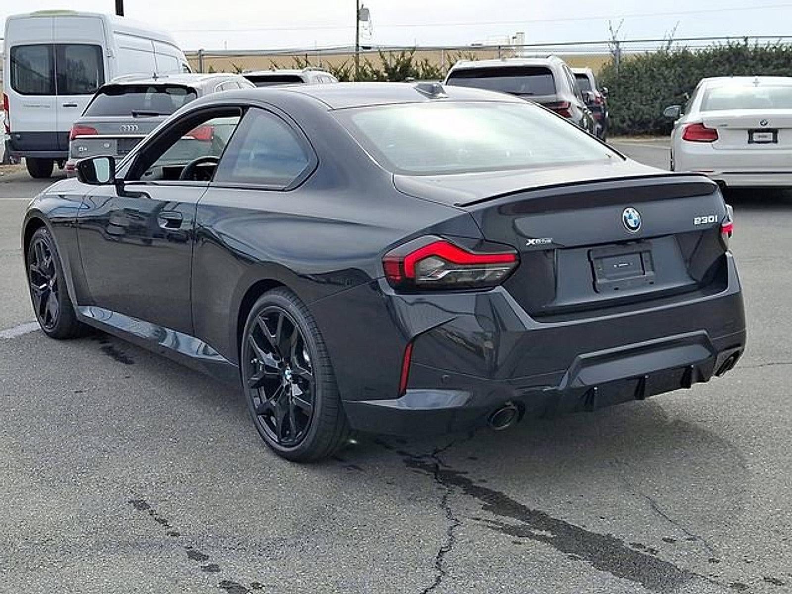 2026 BMW 230i xDrive — rear three-quarter view
