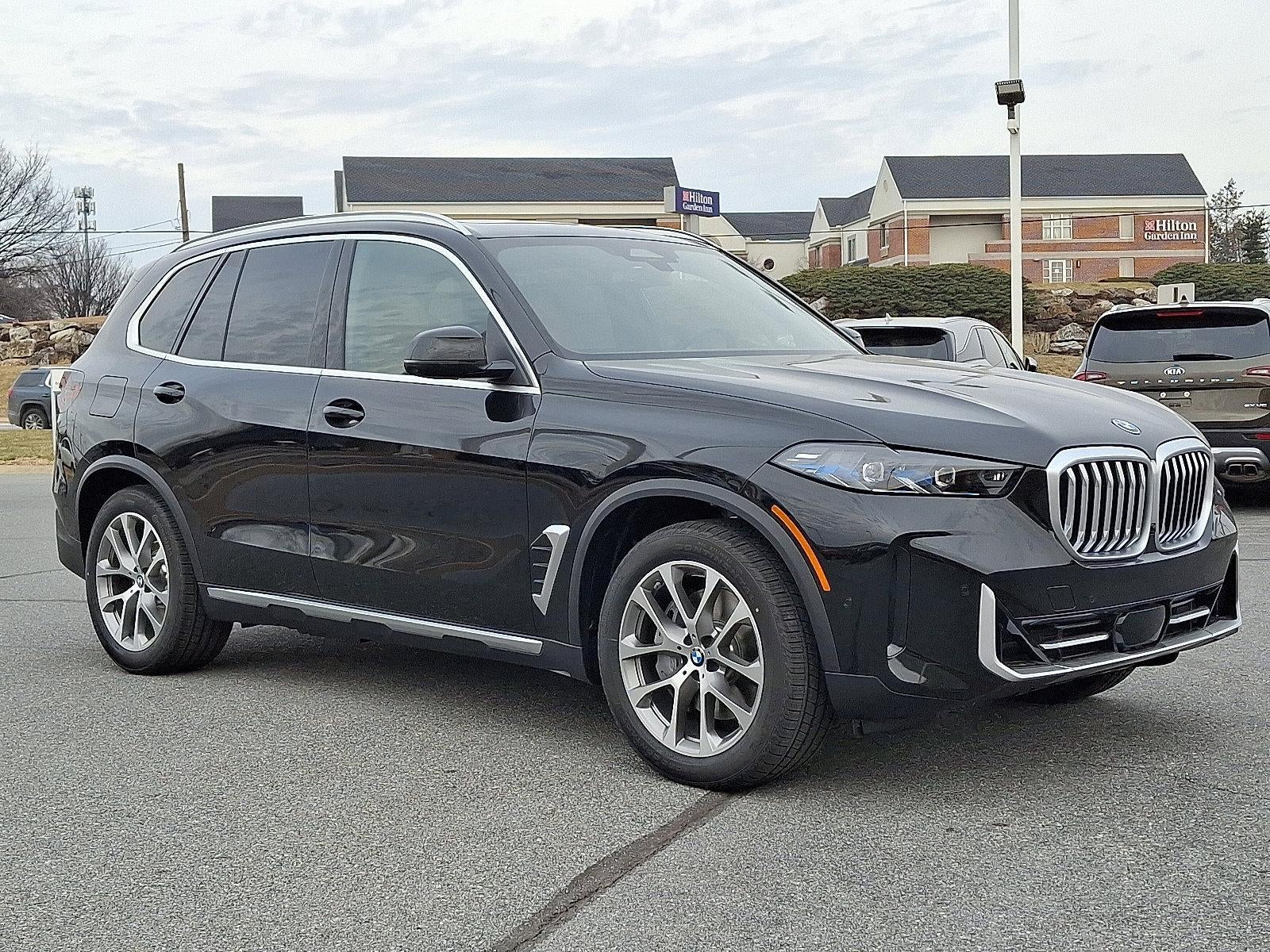 2026 BMW X5 xDrive50e Plug-In Hybrid in Black Sapphire Metallic — front three-quarter view