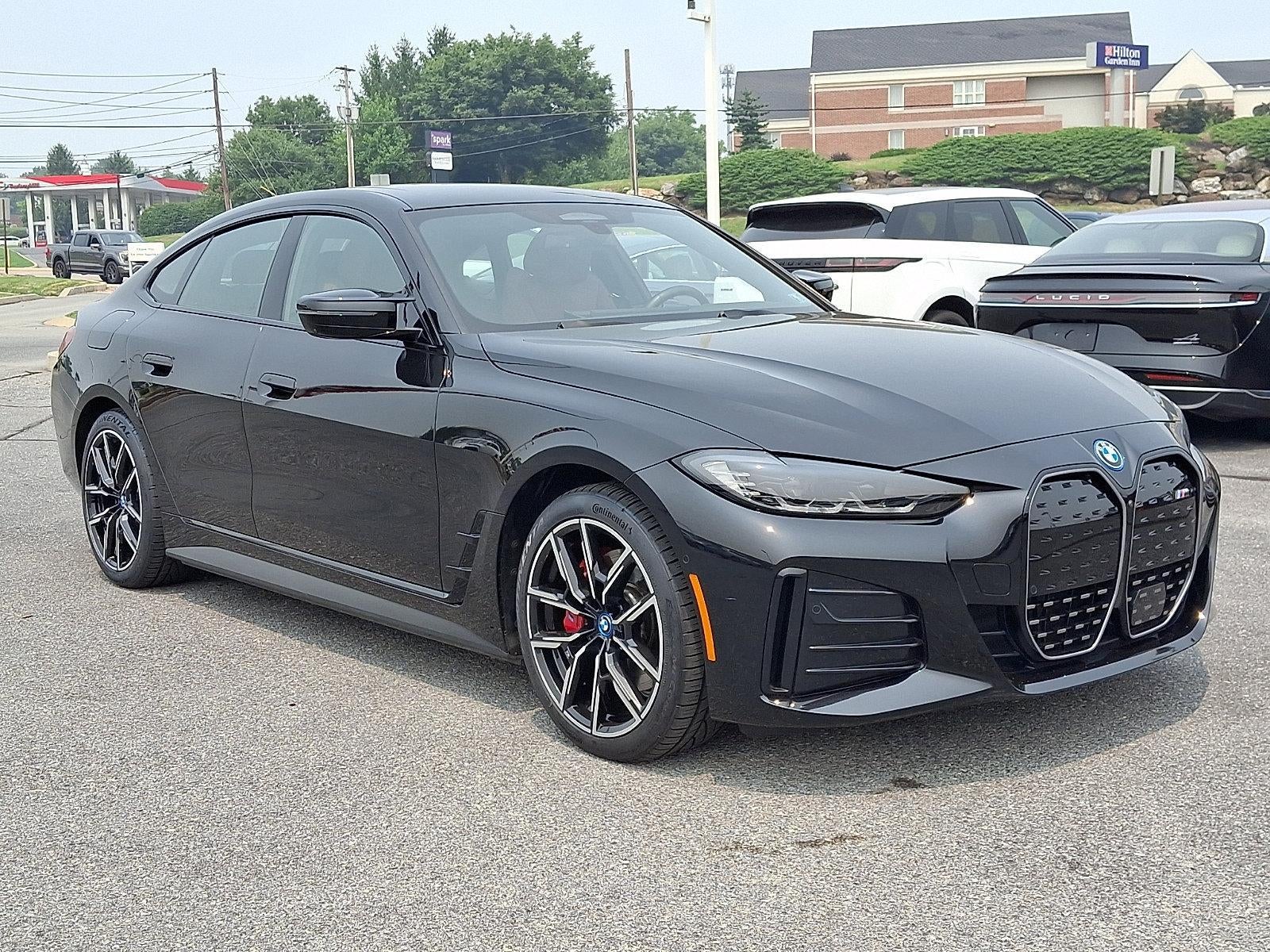 2024 BMW i4 Gran Coupe in Black Sapphire Metallic — front three-quarter view