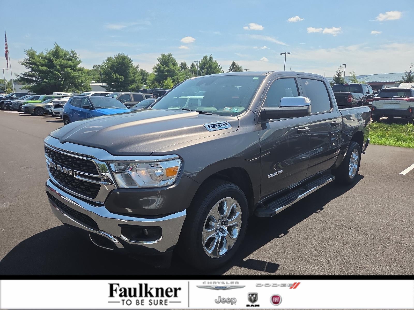 2023 RAM 1500 Big Horn 4x4 Crew Cab 5'7" Box in Granite Crystal Metallic Clearcoat — front three-quarter view